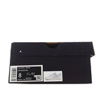 Black shoebox with product label and small sneaker graphic
