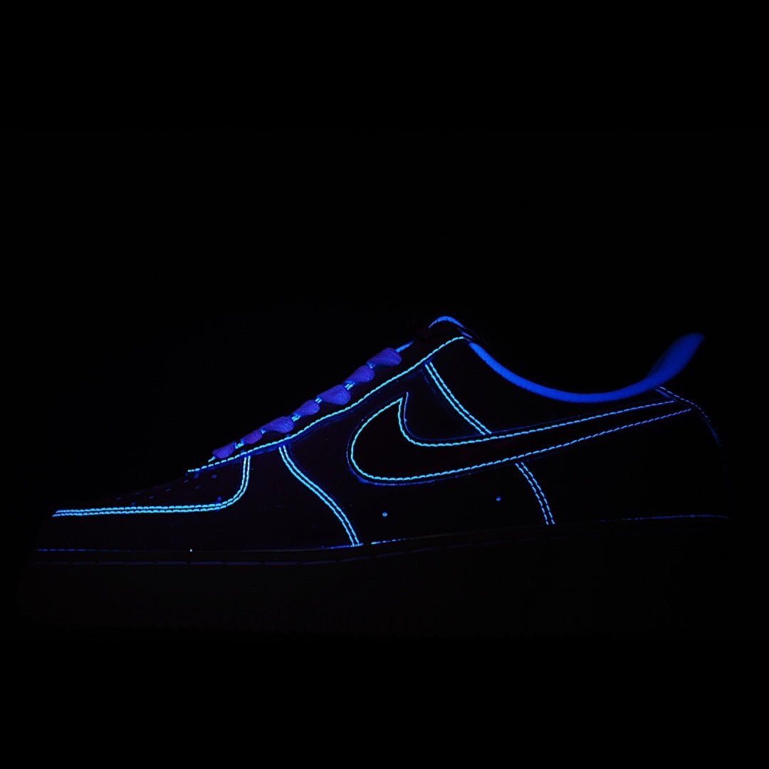 Black low-top sneaker with blue neon outline and lace-up design