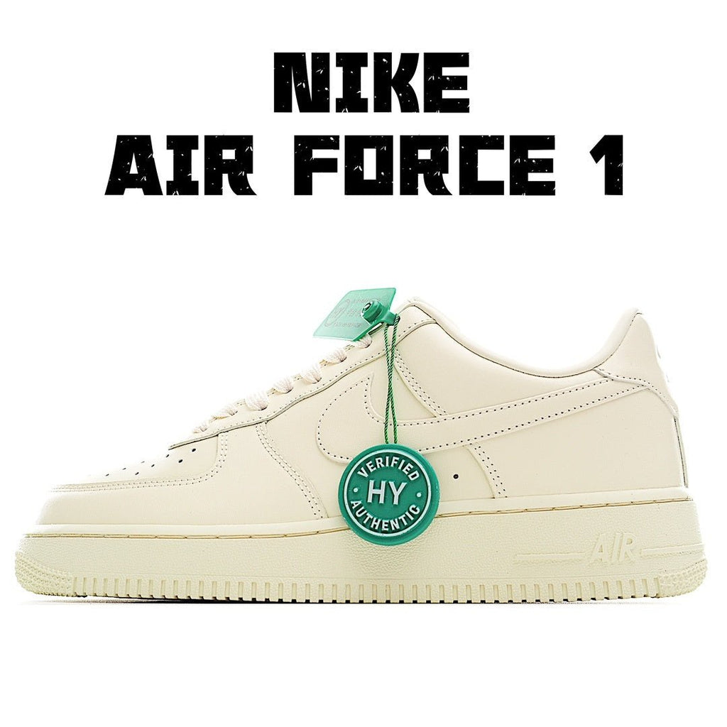 Cream leather low-top sneaker with green tag and white laces, perforated toe