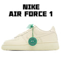 Cream leather low-top sneaker with green tag and white laces, perforated toe