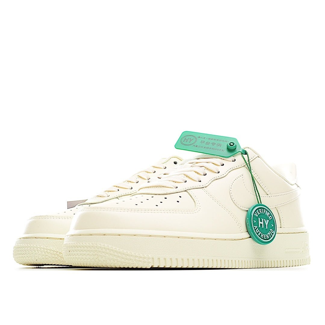 Cream leather low-top sneaker with white laces and green-tag detail, side profile