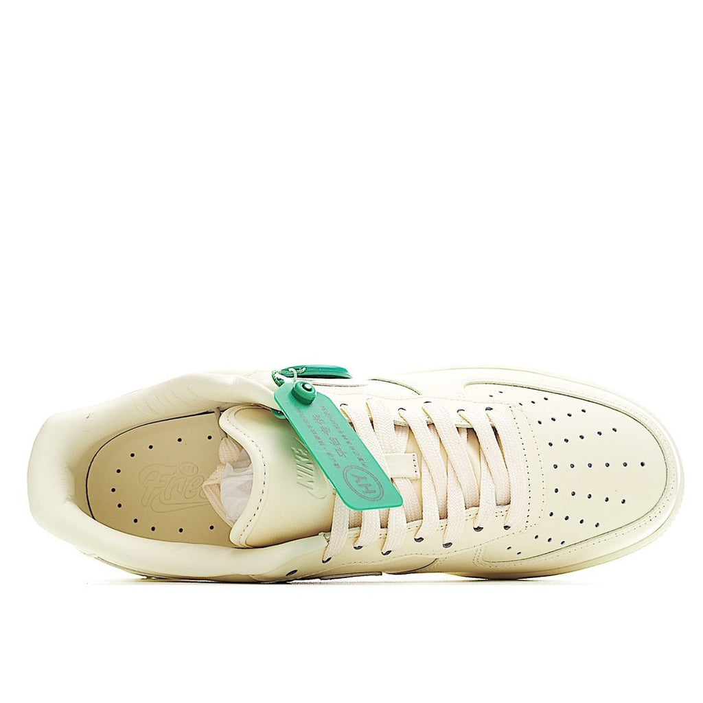 Cream leather low-top sneaker interior view with green lace tag and padded collar