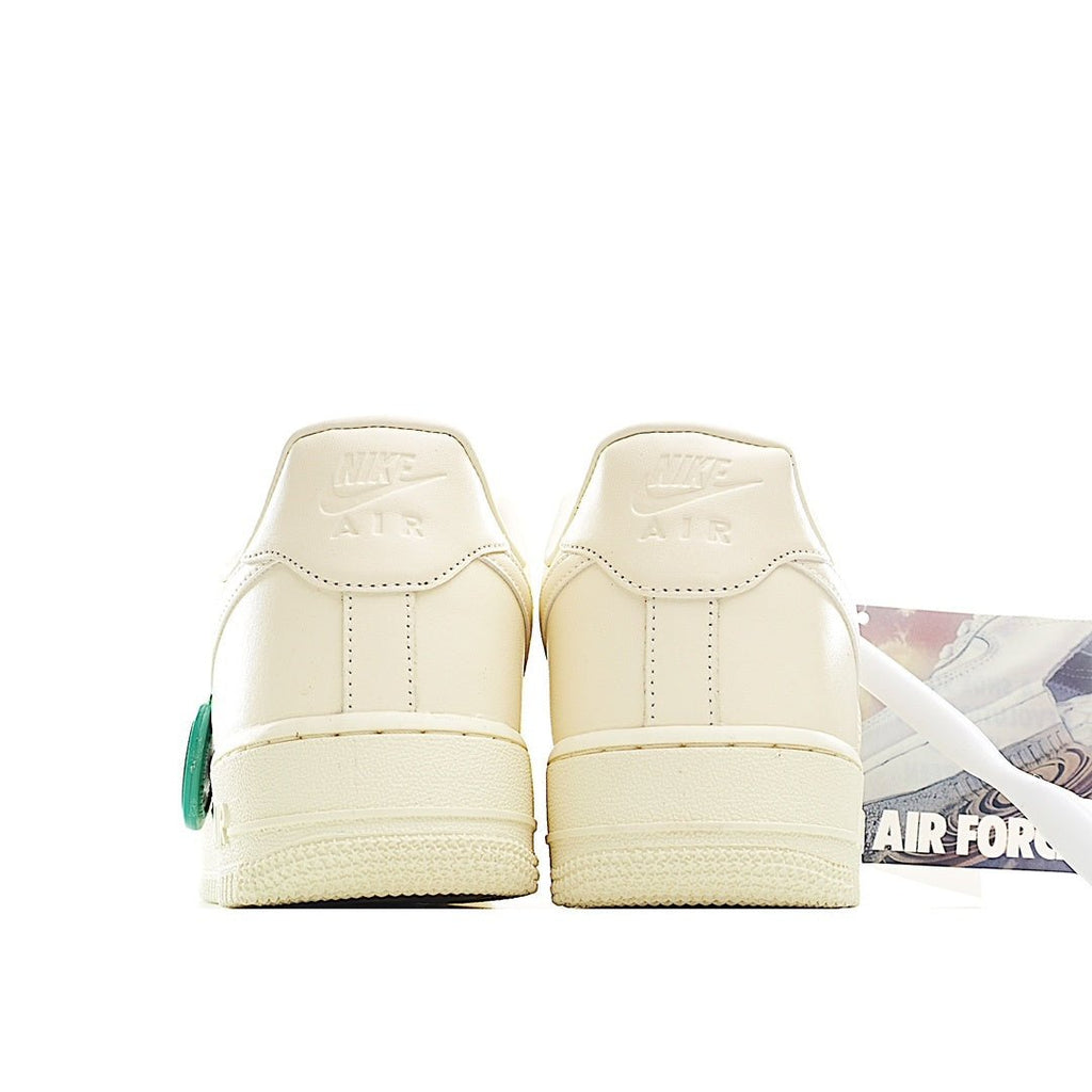 Cream leather low-top sneakers, padded heels with green lace pull tab