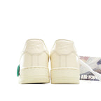 Cream leather low-top sneakers, padded heels with green lace pull tab