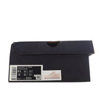 Black shoe box with size label and barcode, shown closed