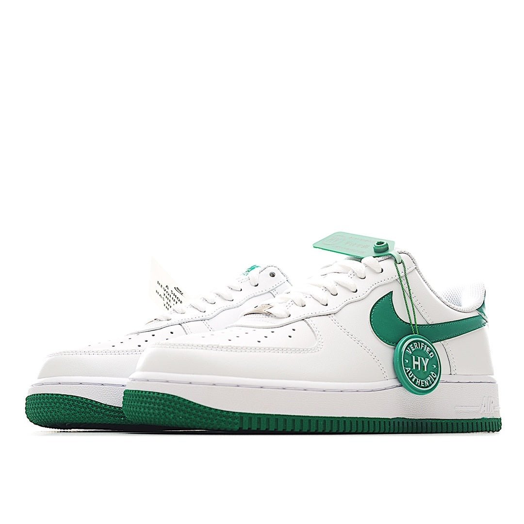 Nike Air Force 1 low-top sneakers, side view; white upper with green swoosh and sole
