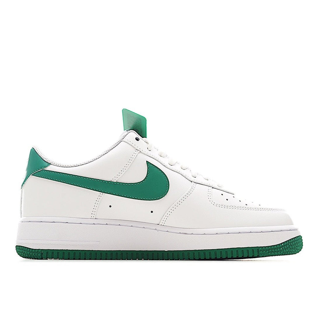 Nike Air Force 1 low-top sneakers, quarter view; white leather with green swoosh