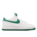 Nike Air Force 1 low-top sneakers, quarter view; white leather with green swoosh