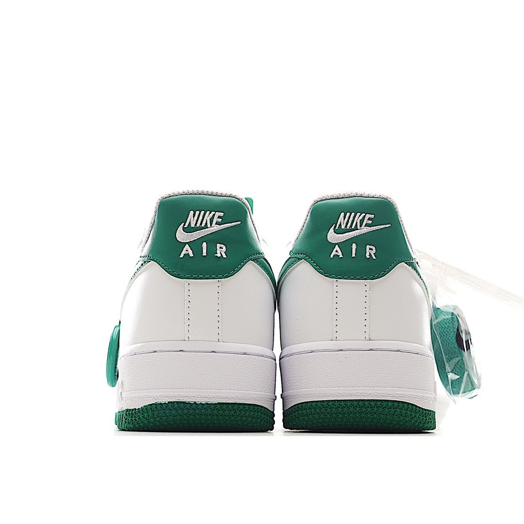 Nike Air Force 1 low-top sneakers, back view; white uppers with green heel panels