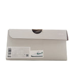 Sneaker box, light gray with Nike logo and barcode label on the side