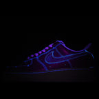 Dark blue low-top sneakers with glowing neon-style trim and lace-up front
