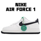 White low-top sneaker with black swoosh and green lace details, side view