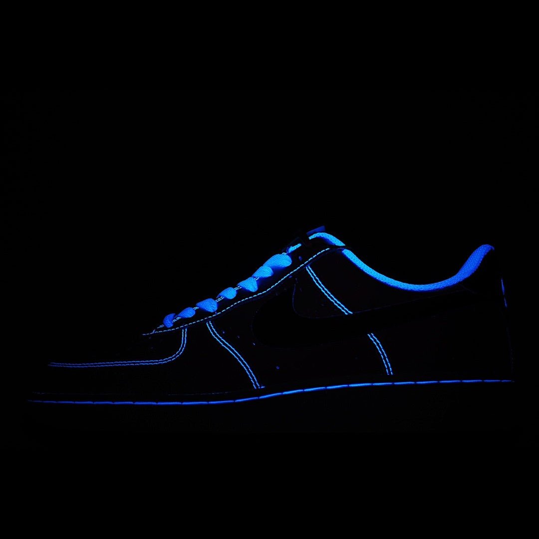 Dark sneaker with blue glowing outline and lace-up upper