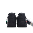 Nike Air Force 1 Low black sneaker heel, green accent pull and logo
