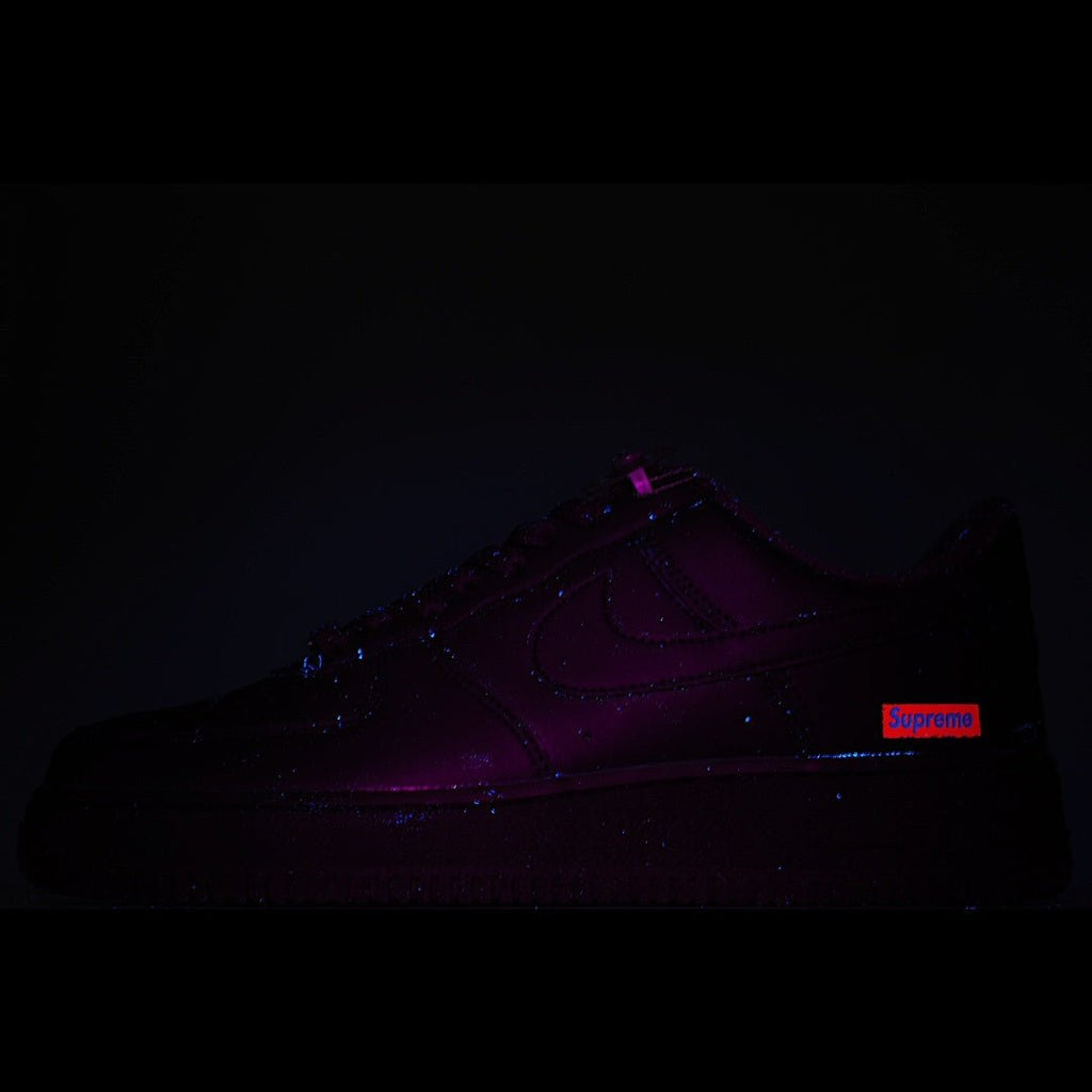 Nike Air Force 1 Low sneaker with purple and red glow accents