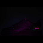 Nike Air Force 1 Low sneaker with purple and red glow accents