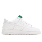 White low-top sneaker with green tongue pull tab and stitched Swoosh