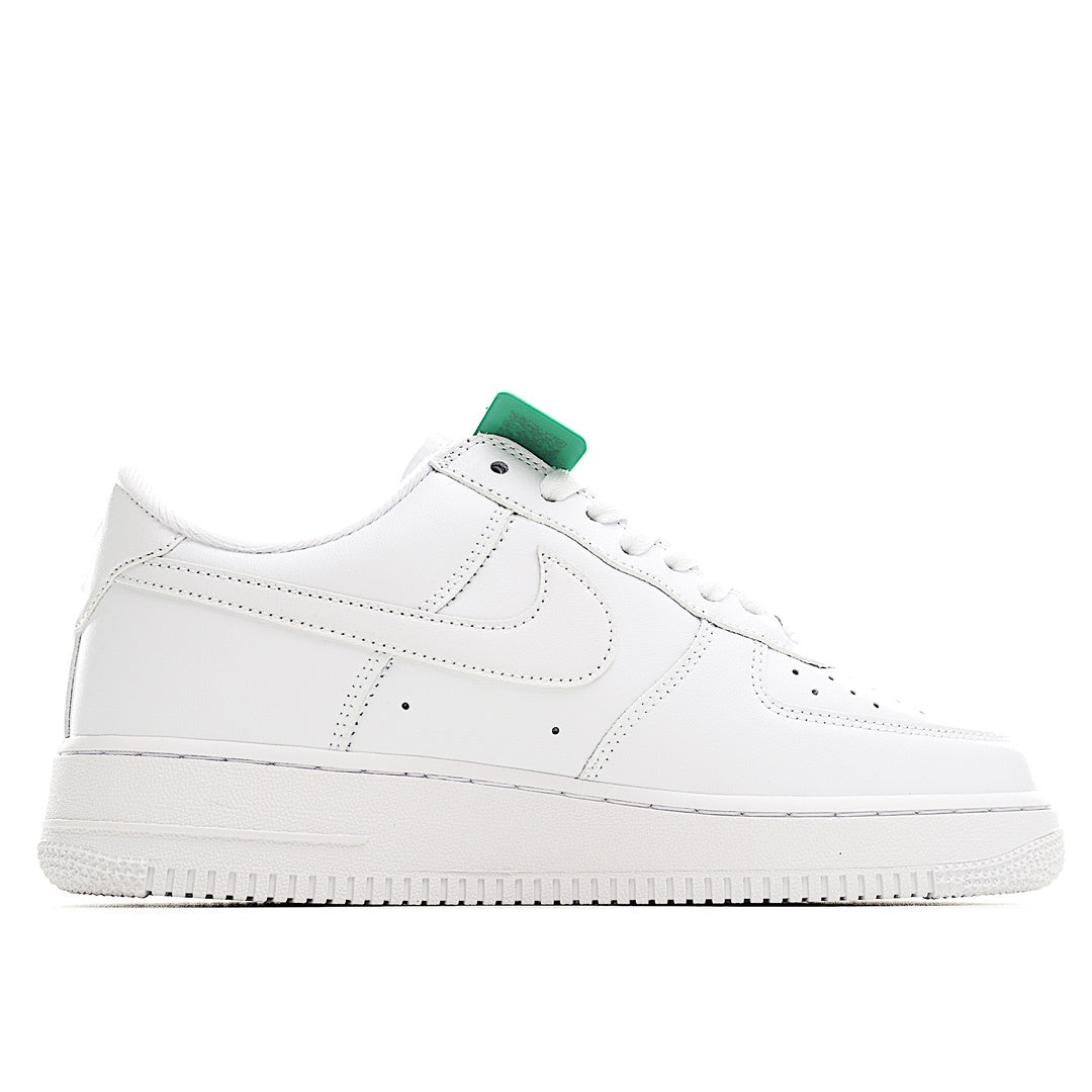 White low-top sneaker with green tongue pull tab and stitched Swoosh