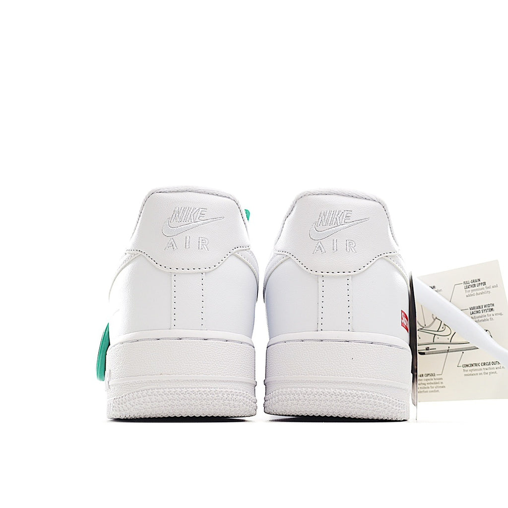 White low-top sneaker heel view with “NIKE AIR” branding and green heel detail