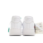 White low-top sneaker heel view with “NIKE AIR” branding and green heel detail