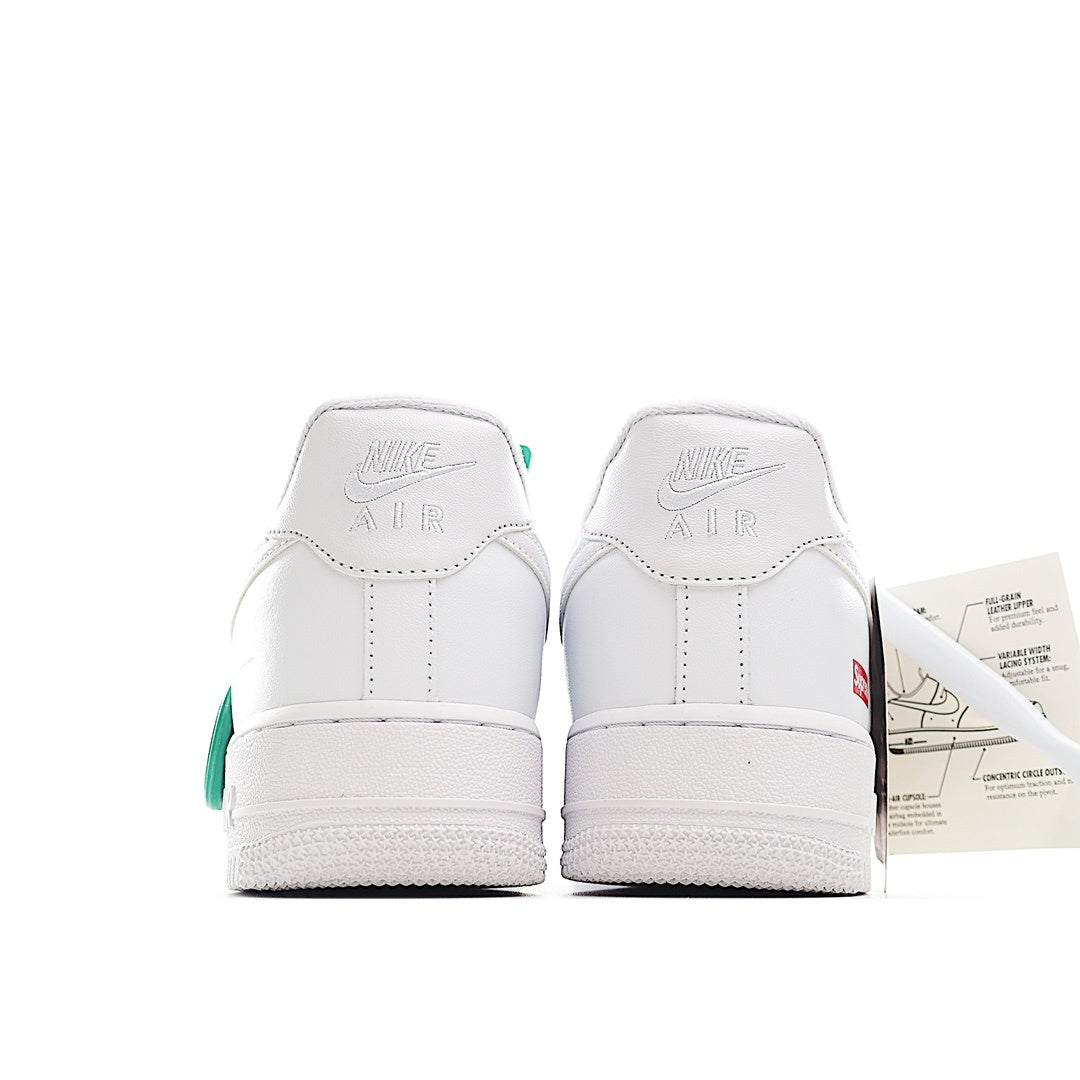 White low-top sneaker heel view with “NIKE AIR” branding and green heel detail
