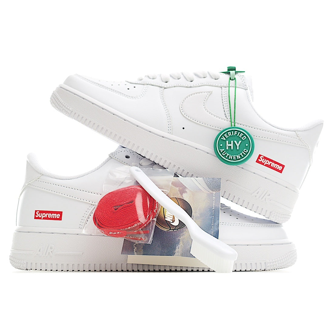 White low-top sneaker with green lacing tag and Supreme heel label