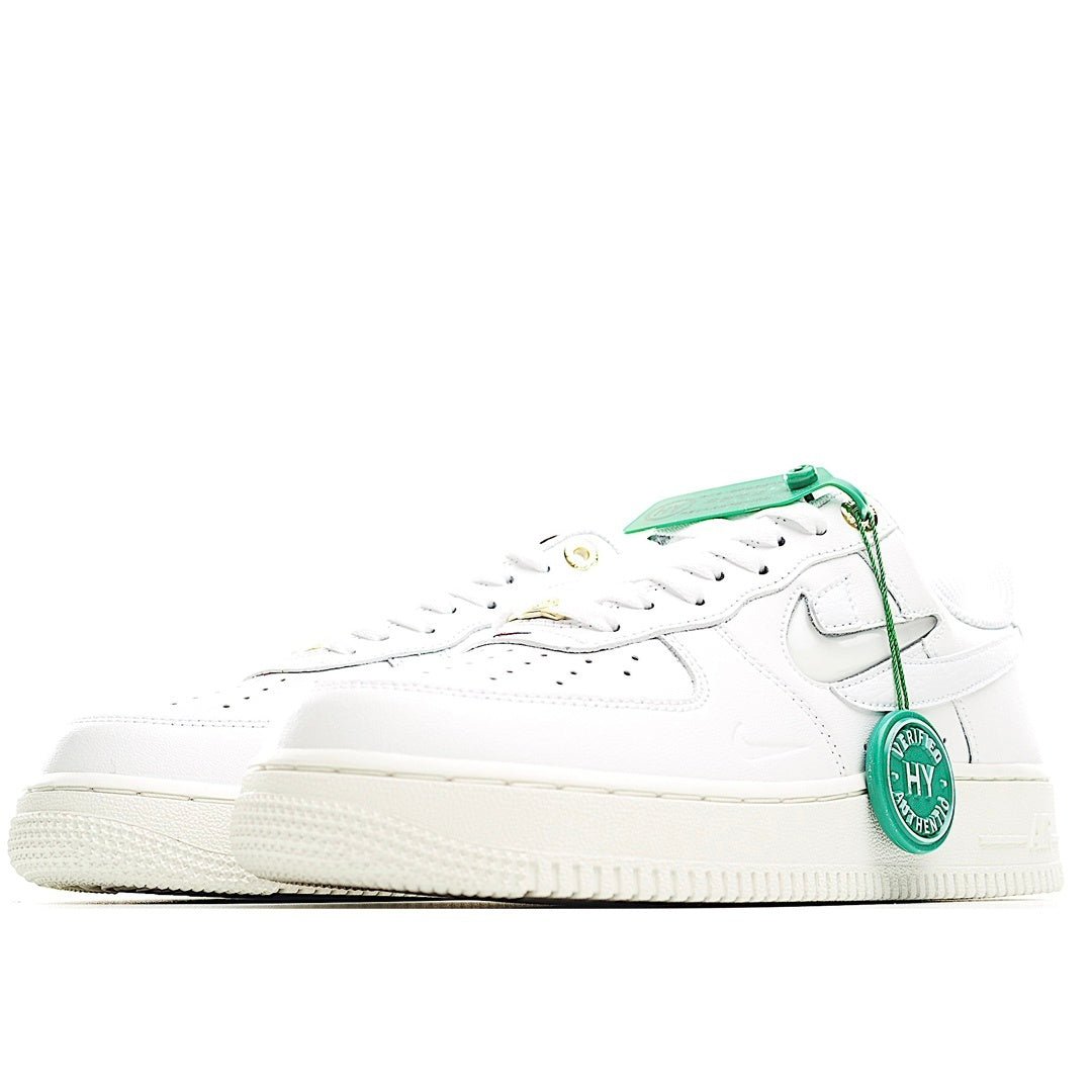 White Nike Air Force 1 low sneakers, side view, green strap and lace tag