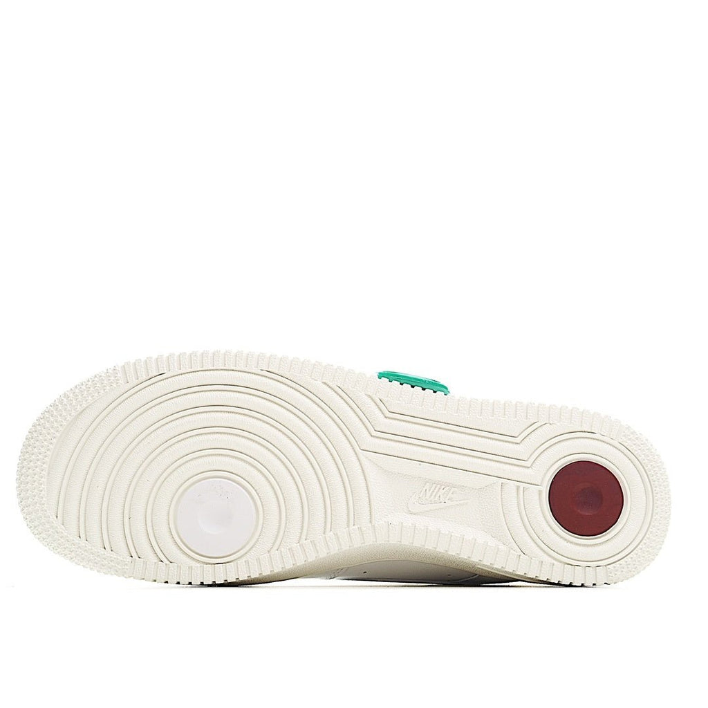 White Nike Air Force 1 outsole with circular red traction patch and green tab