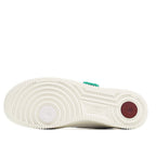 White Nike Air Force 1 outsole with circular red traction patch and green tab