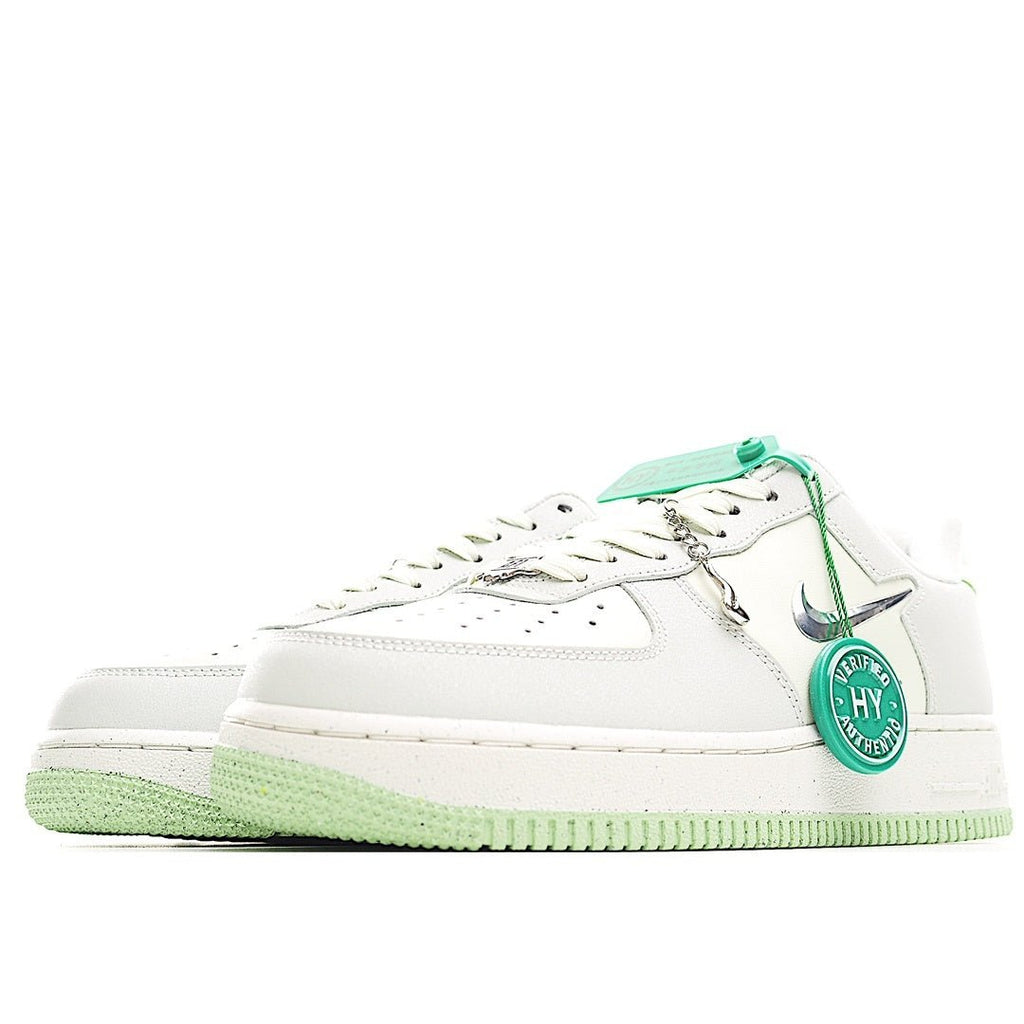 White Air-style low-top sneakers with green laces and matching green rubber outsole