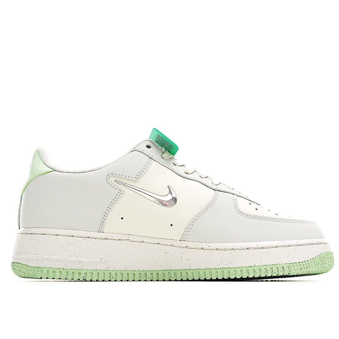 White low-top sneakers with green lace accents, swoosh logo, and flat textured sole