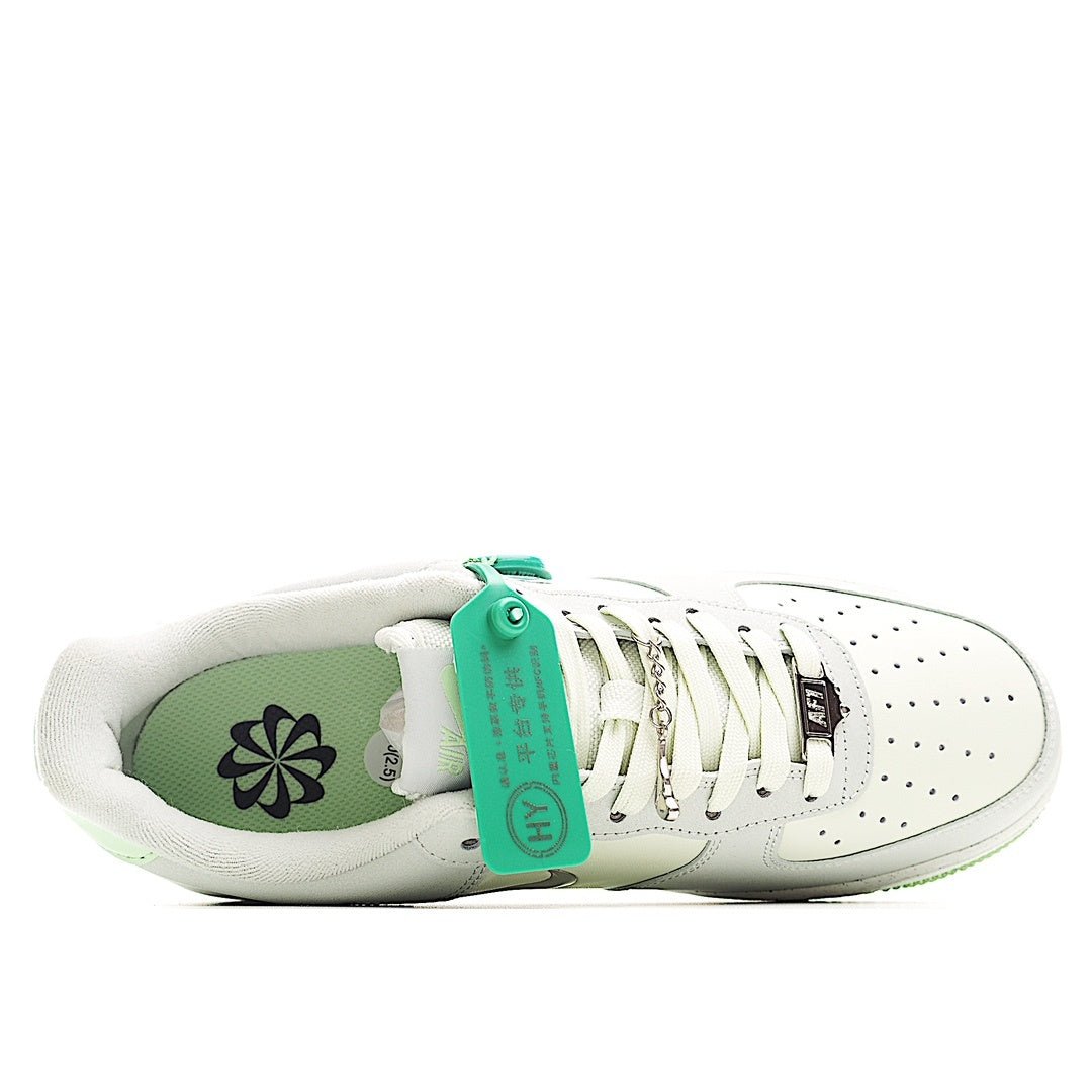 White low-top sneakers with green insole, lace loops, and cushioned padded collar