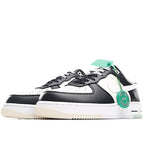 Low-top Nike Air Force 1-style sneaker, black and white panels with green lace tag.