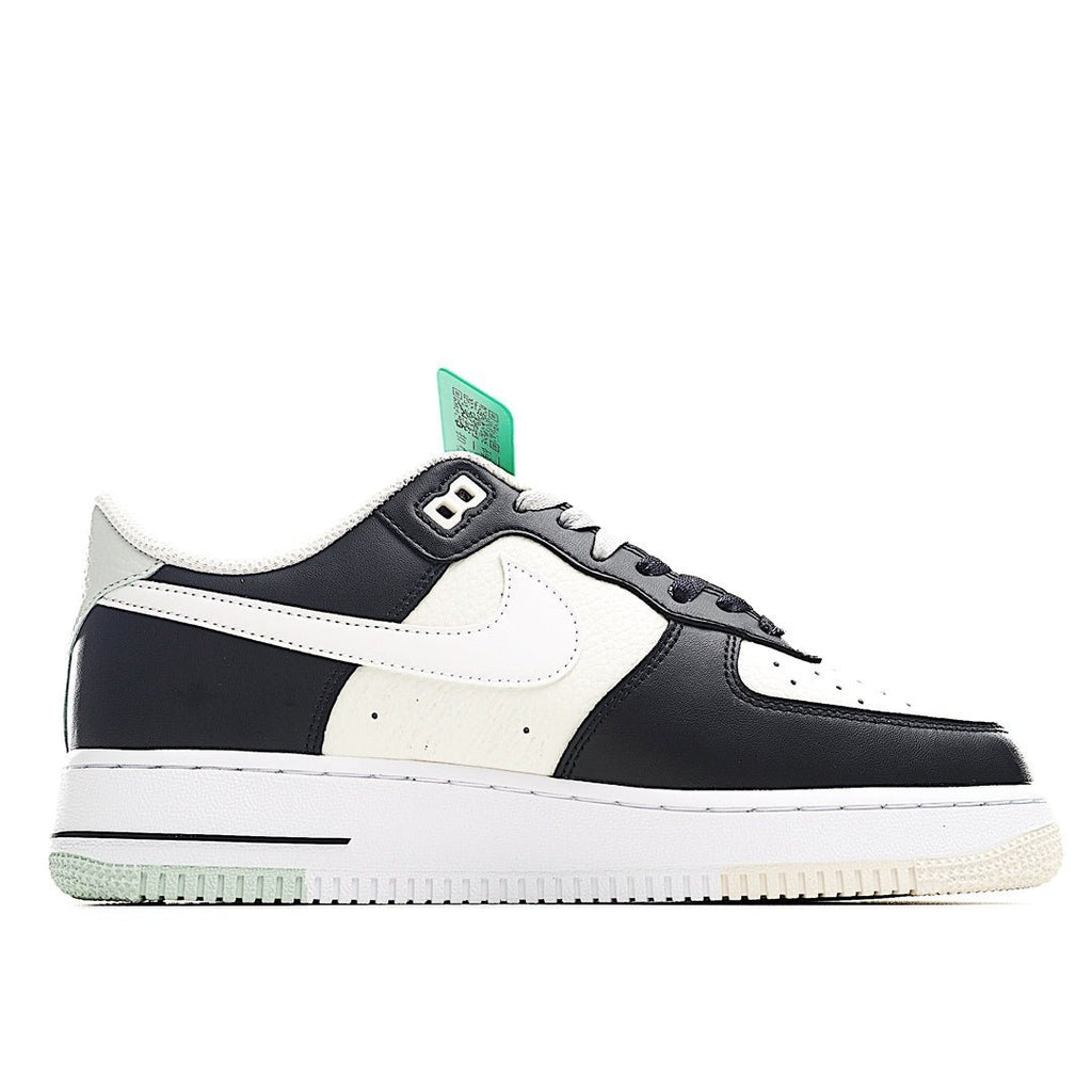 Low-top Nike Air Force 1-style sneaker, white upper with black overlays and green tag.