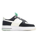Low-top Nike Air Force 1-style sneaker, white upper with black overlays and green tag.