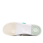 Sneaker outsole view, textured white rubber with light green edge detail.