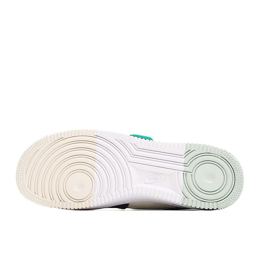 Sneaker outsole view, textured white rubber with light green edge detail.