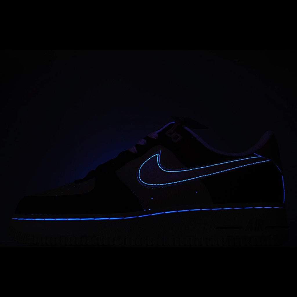 Dark low-top sneaker with blue swoosh outline detail.