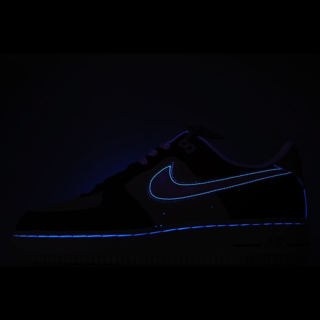Dark low-top sneaker with blue swoosh outline detail.