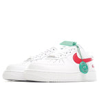 White low-top sneakers with red swoosh detail and green hang tag, side view