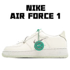 White Nike Air Force 1 sneakers with green lace tips and HY authentication badge