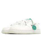 White Nike sneakers with green laces and HY authentication badge, side view