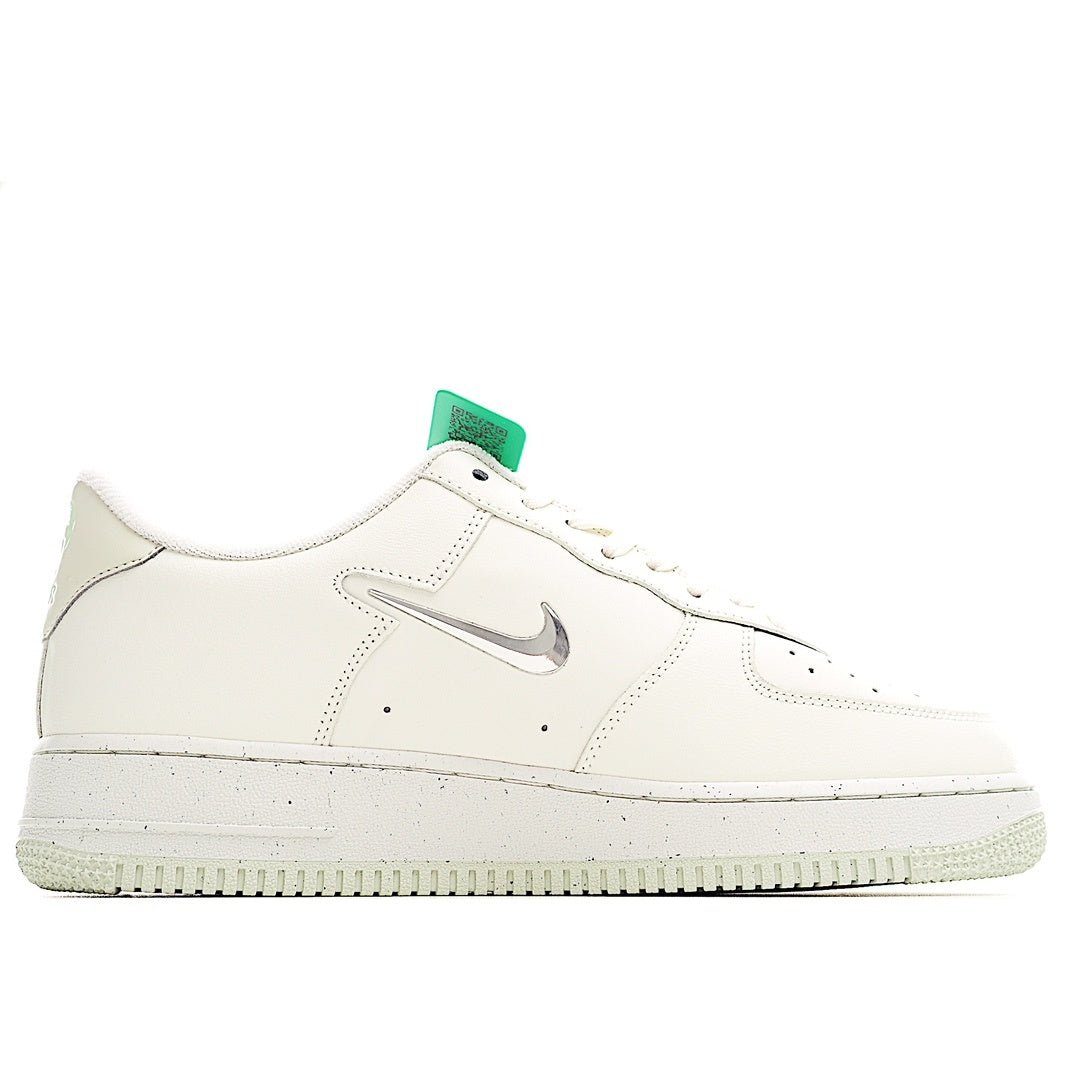 White Nike sneakers with grey swoosh and green heel tab