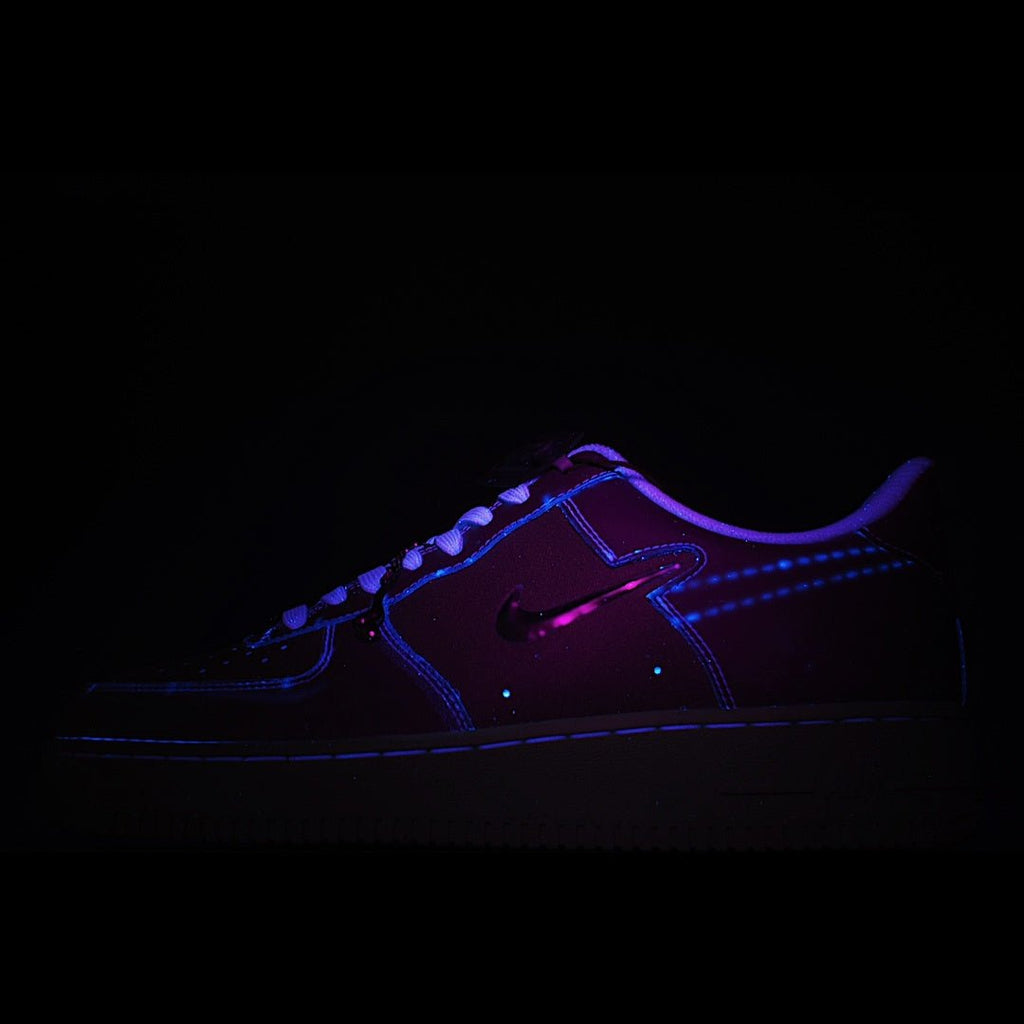 Dark Nike sneakers with purple upper and blue glowing outline