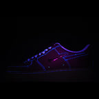 Dark Nike sneakers with purple upper and blue glowing outline