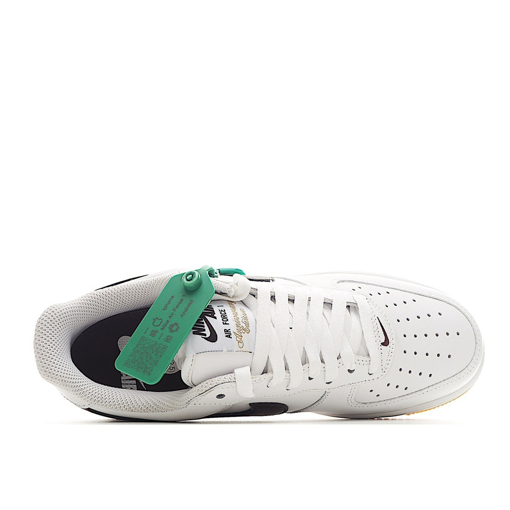White low-top sneaker with green inner tag, dark lining, and tan sole
