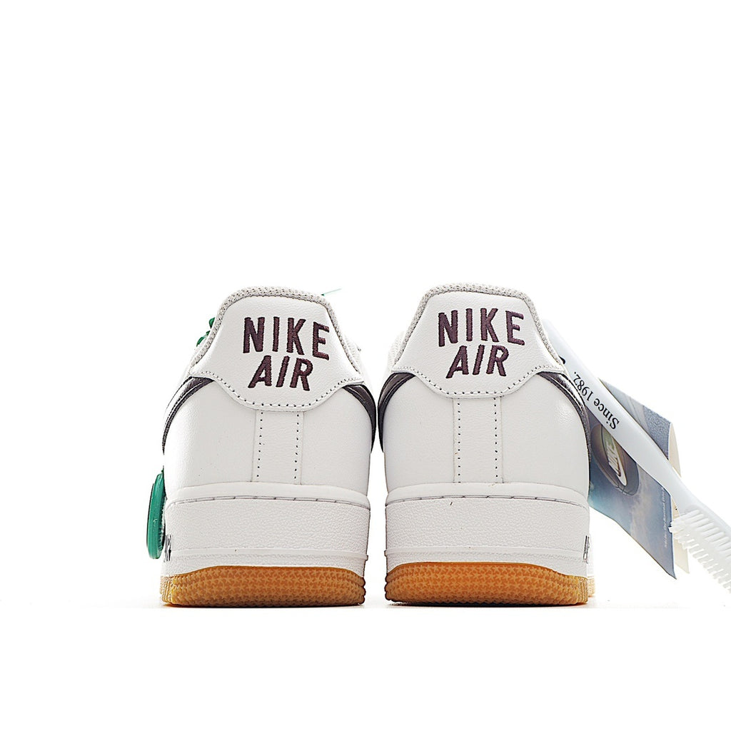 White sneaker heel view with Nike Air text, green accents, and tan sole
