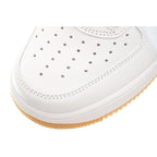 White toe area of sneaker with perforated detailing and textured sole edge