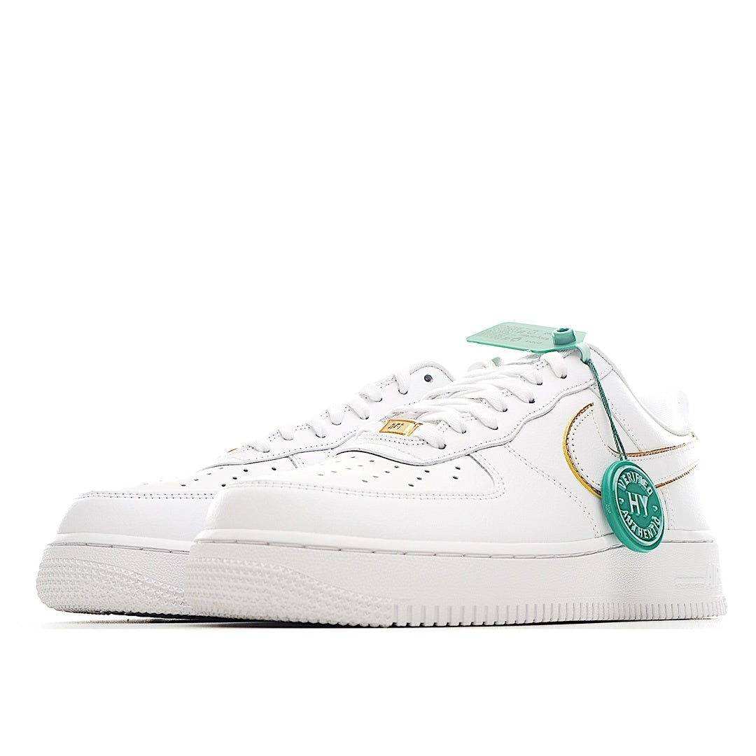 White Air Force 1 sneaker with green lace tag and gold-trim swoosh, side view.