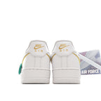 White Air Force 1 heel pair with NIKE Air text, green lace accents, rear view.
